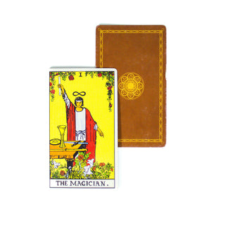 The Magician from the Rider Waite tarot deck is yellow with the image of a man in red robe holding a wand. All four suits are represented- cups, pentacles, swords and wands. A second card in the background shows the back of the cards- brown with a golden mandala in the center.