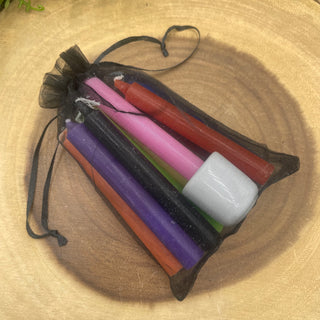 10 rainbow colored chime candles in a sheer black bag packaged with white ceramic chime holder. 