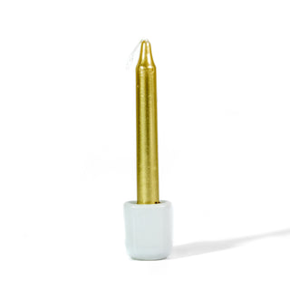 Small gold metallic chime spellwork candle in white chime holder against a white background.