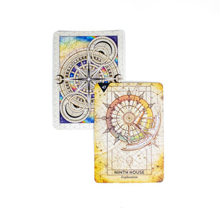 The Ninth House Exploration card from the Starcodes Astro deck is golden in color and shows astrological instruments in a compass sphere. A second card behind it shows the back of the deck with compasses and sacred geometry.