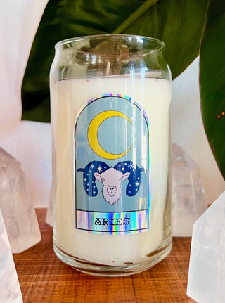 Front of Aries zodiac candle with hologrpahic sticker of ram and crescent moon.