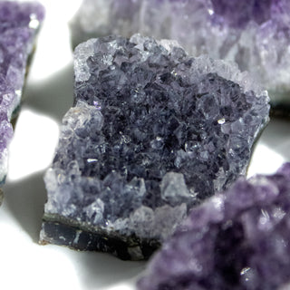 Close up of chunk of raw amethyst with dark purple coloring. 