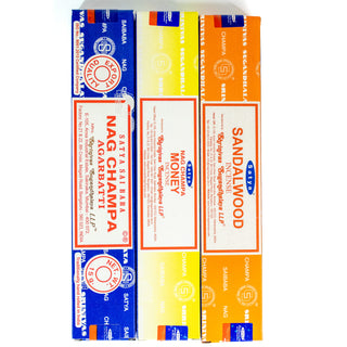 Three small boxes of Nag Champa incense, blue, yellow and orange boxes of different varieties.