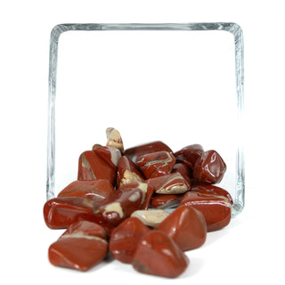 Several tumbled red jasper pocket stones with natural tan and grey striping. 