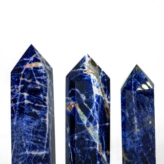 Three sodalite generators showing natural variation in color and size. All shades of blue with white and light pink accents.