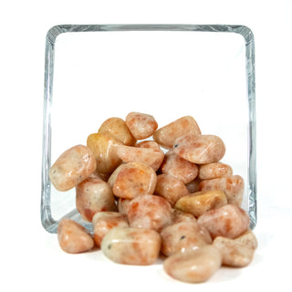 Several tumbled sunstone pocket stones showing natural variations of color of orange, reds and yellows