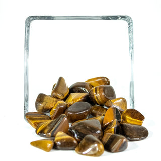 Several tumbled tigers eye pocket stones in natural striping of golden and brown hues. 