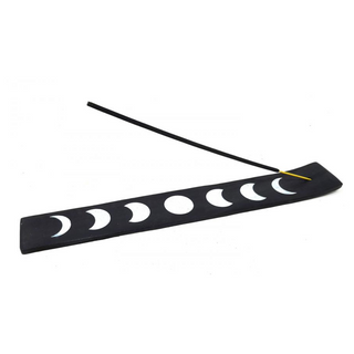 Black and White phases of the moon incense holder for stick incense. Black wood with white moons. Holding a stick of incense.