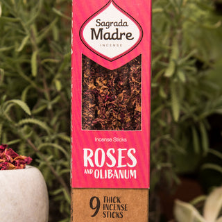 Close up of Roses and Olibanum box showing the rose petal covered incense inside. Top of box is pink. 