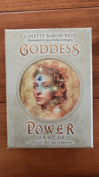 Box of the Goddess Power Oracle Deck by Colette Baron Reid. Box is tan with a woman shown surrounded by gold and stars in the center. 
