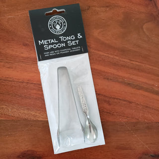 Metal tong and spoon set in plastic packaging with black label.