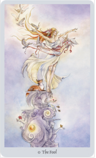 The Fool Card from the Shadowscapes tarot deck shows a woman with flowing white dress, her arms outstretched with doves flying aroun dher. She is standing on an elaborate pillar. 