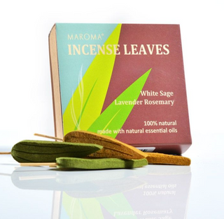 Box of Maroma Incense Leaves is blue and brown with green leaf drawings. In front are four leaf shaped incense sticks in green and brown.