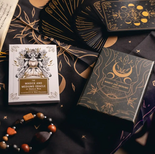 The Magick and Mediums box is shown with the white guidebook and several cards