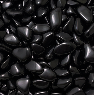 Close up of several dozen black obsidian pocket stones. Each stone is black with a reflective sheen. 