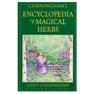 Cover of Cunningham's Encyclopedia of Magical Herebs. Cover is green with yellow text. There is a color painting of a woman dressed in a purple robe in a forest with flowers. She is blowing herbs that fly up into the air and there is a deer behind her.