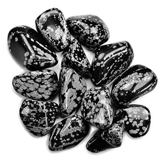 Several black snowflake obsidian tumbled pocket stones with white, light grey spotting.