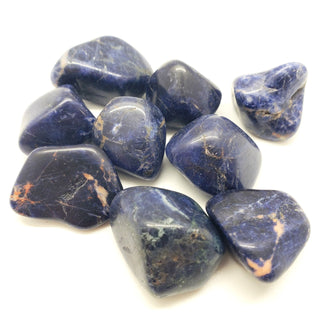 Several blue sodalite tumbled pocket stones with natural variation in color including light and dark blue, greys, black, pink, white. 